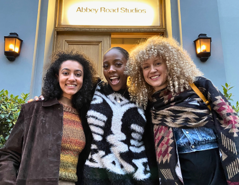 Three songwriters standing outside Abbey Road