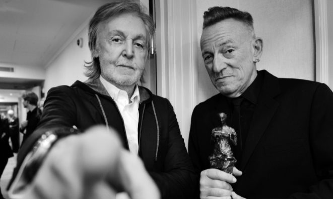 Ivors Academy Fellows Paul McCartney and Bruce Springsteen looking into the camera at The Ivors 2024