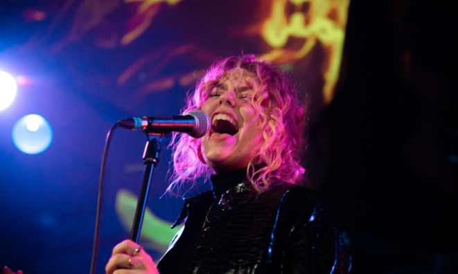 Woman singing with eyes closed
