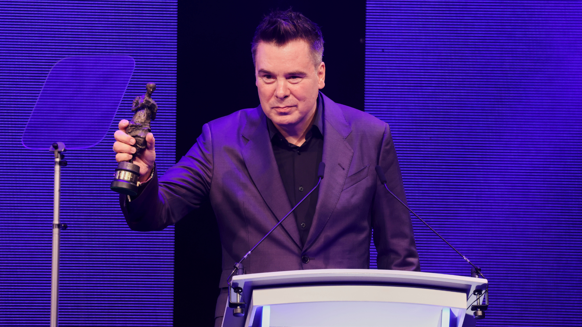 CEO of The Ivors Academy Roberto Neri holding an Ivor Novello Award at The Ivors 2026.