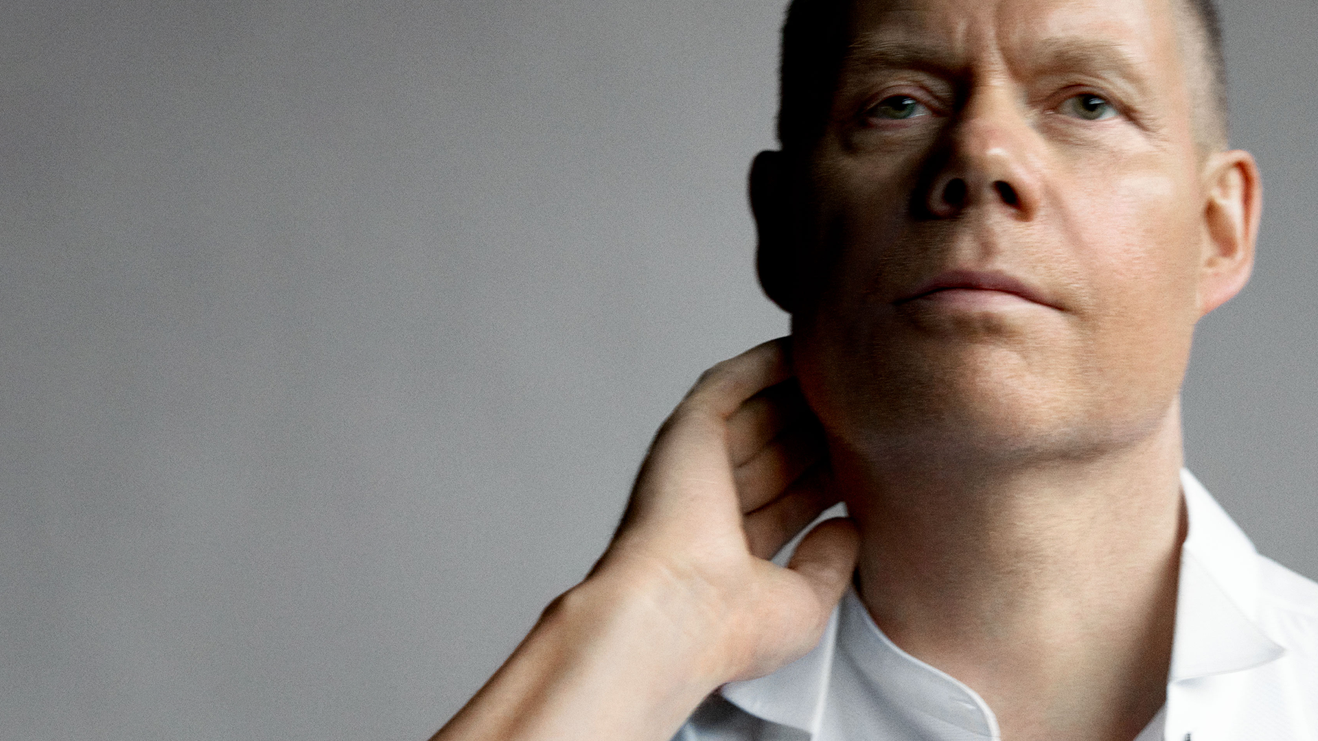 Composer Max Richter in a white shirt in front of a grey background